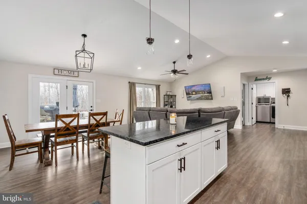 a kitchen with counter space dining table and chairs