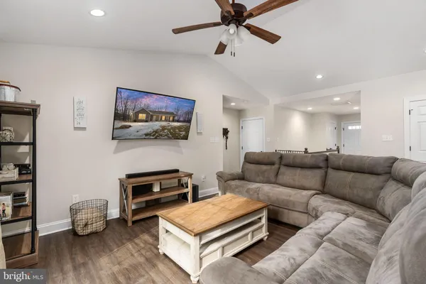 a living room with furniture and kitchen view