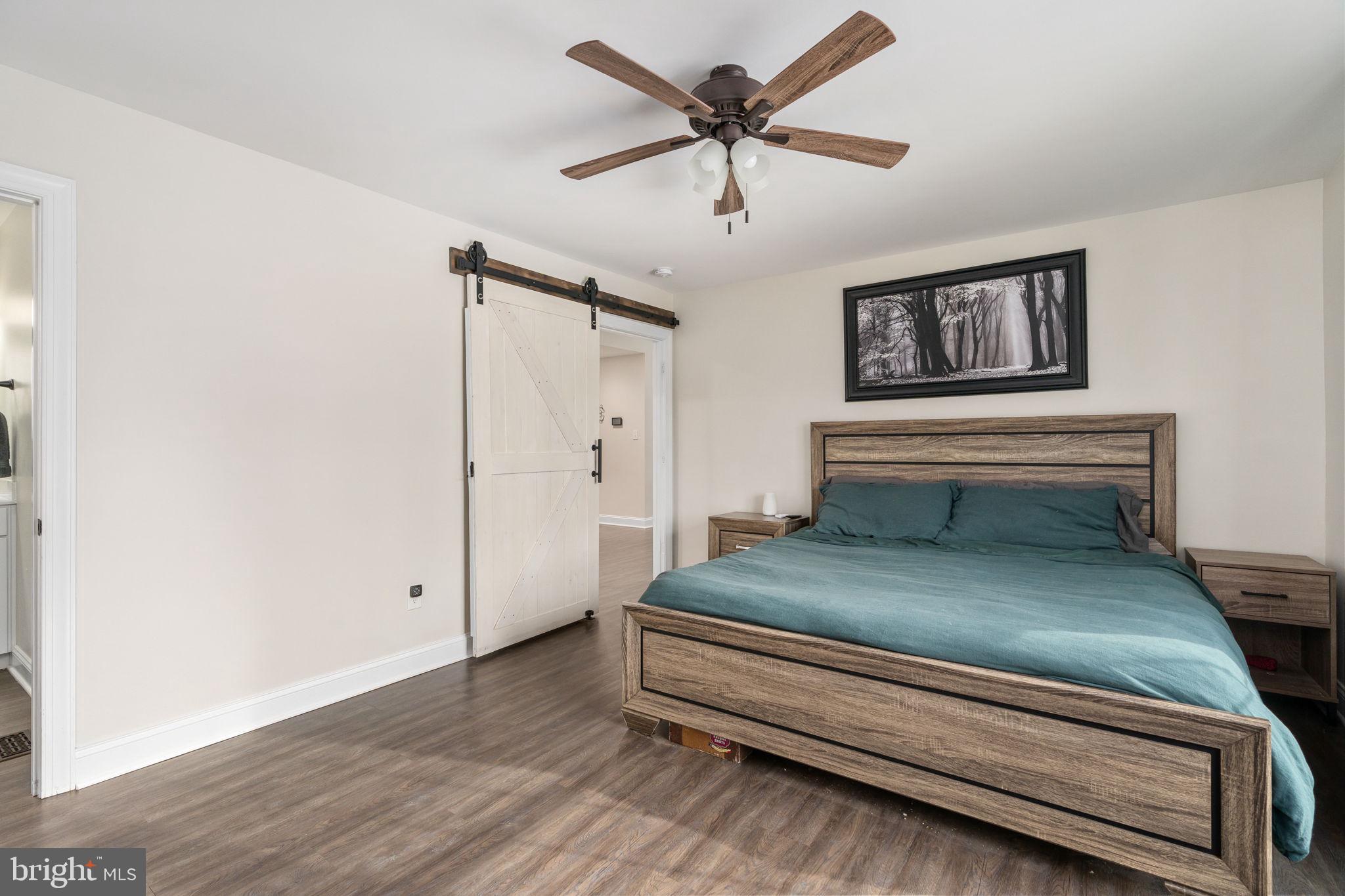 10514 Hart Court Culpeper, VA 22701 - Photo 15 of 34 a bedroom with a bed and a chandelier