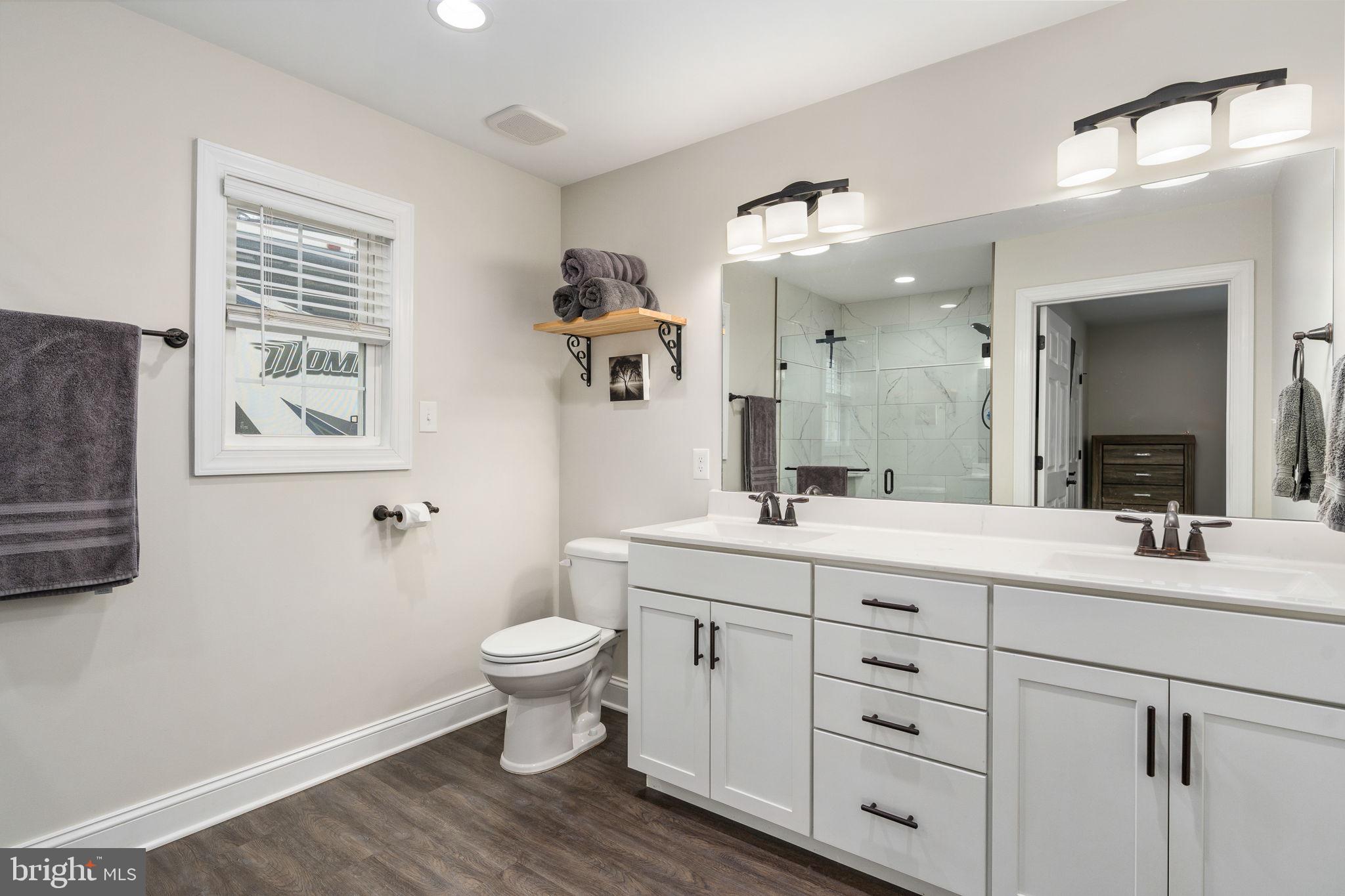 10514 Hart Court Culpeper, VA 22701 - Photo 16 of 34 a bathroom with a double vanity sink a toilet and a mirror