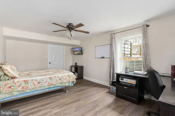 a bedroom with a bed couch and a window