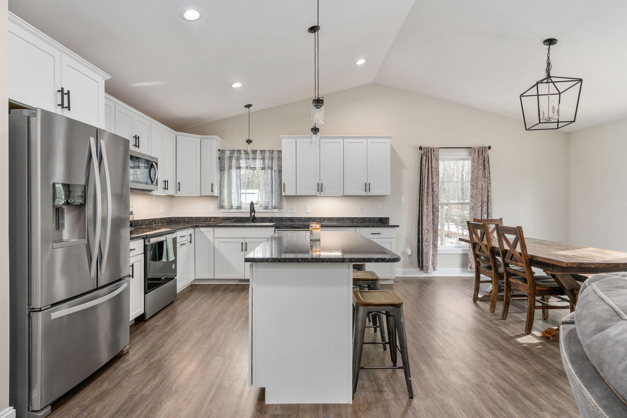 10514 Hart Court Culpeper, VA 22701 - Photo 5 of 34 a kitchen with stainless steel appliances a refrigerator a stove a sink dishwasher a dining table and chairs with wooden floor
