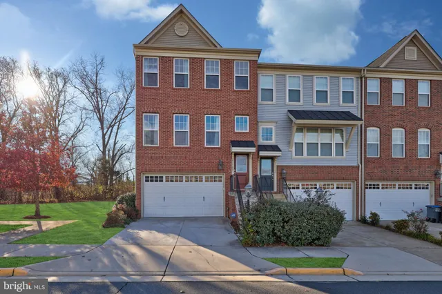 a front view of a residential apartment building with a yard
