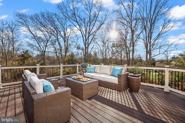 a view of a deck with couches and wooden floor