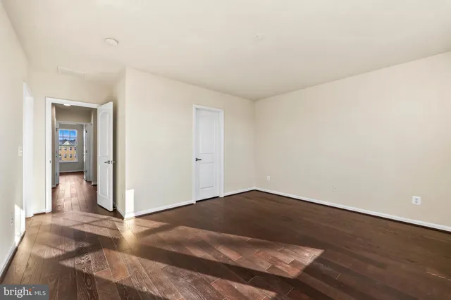 an empty room with wooden floor