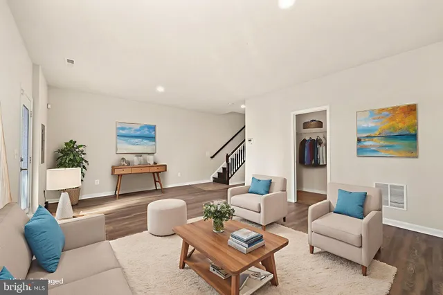 a living room with furniture and a potted plant