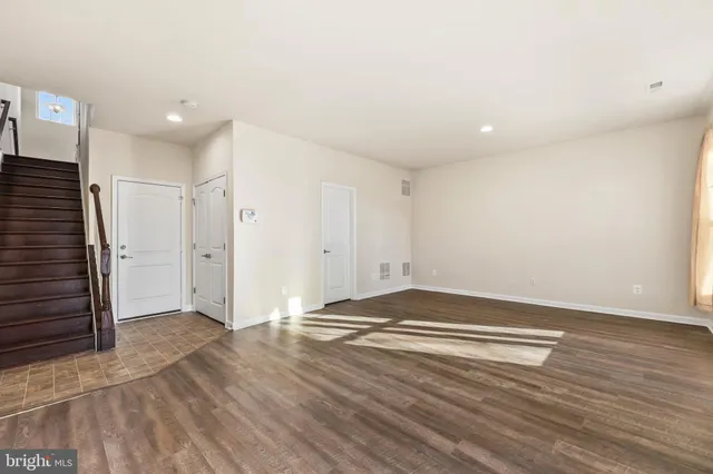 a view of livingroom with hallway and wooden floor