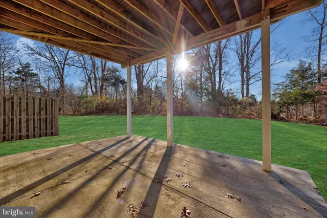 a view of a backyard with wooden fence