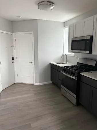 a kitchen with stainless steel appliances granite countertop a stove and a microwave