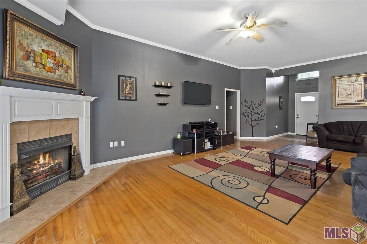 9628 Arnold Road Denham Springs, LA 70726 - Photo 5 of 10 Living Room with beautiful fireplace and wood floors