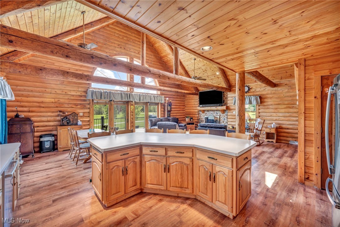 15180 Stoltz Road Diamond, OH 44412 - Photo 48 of 48 Kitchen featuring open floor plan, a fireplace, light wood finished floors, log walls, and wood ceiling