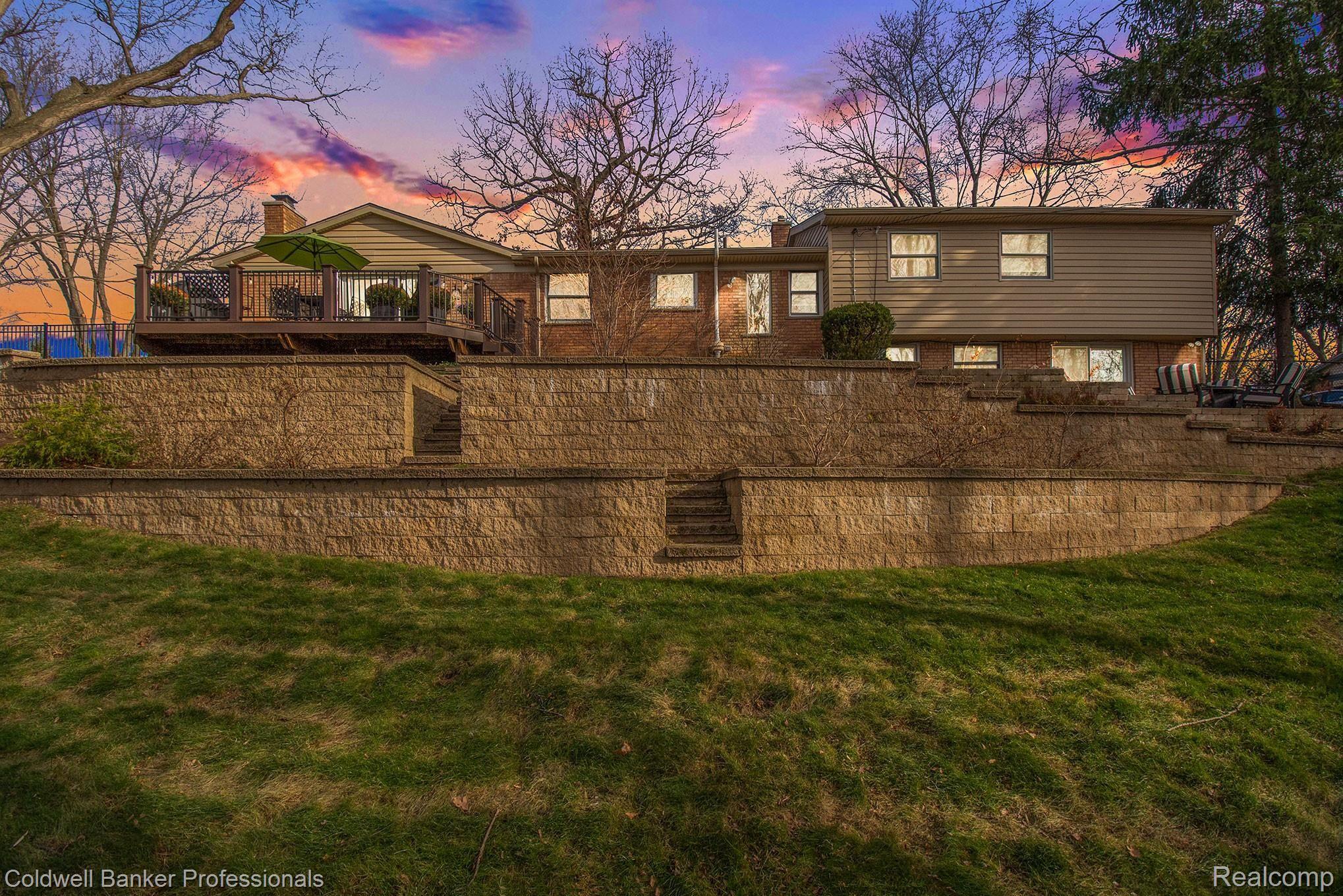 Composite deck and retaining wall added with extensive pavers.  Rooms with a view!