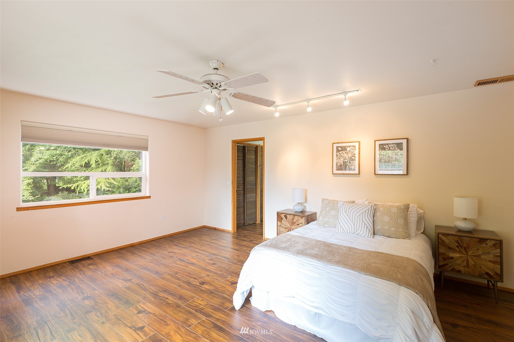 313 Applegate Lane Sequim, WA 98382 - Photo 16 of 40 a bedroom with a large bed and a chandelier