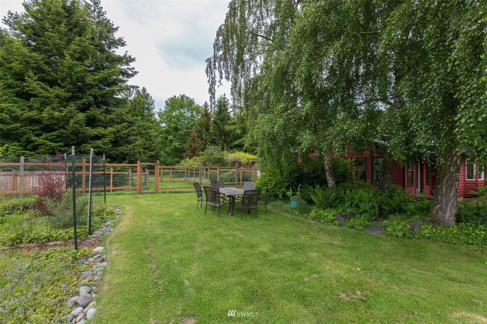 313 Applegate Lane Sequim, WA 98382 - Photo 33 of 40 a view of a chair and table in the garden