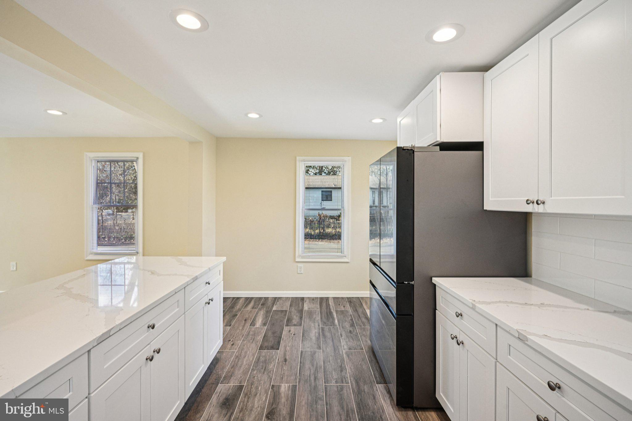 195 Chews Landing Road Clementon, NJ 08021 - Photo 15 of 48 a kitchen with white cabinets and stainless steel appliances
