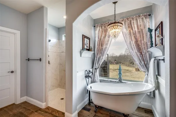 a view of a hallway with wooden floor and a livingroom