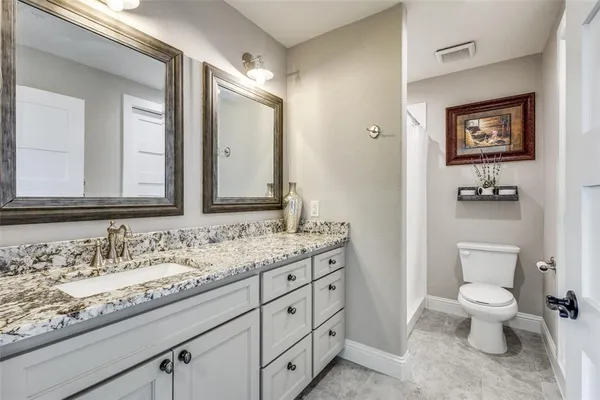a en suite bathroom with a sink and a mirror