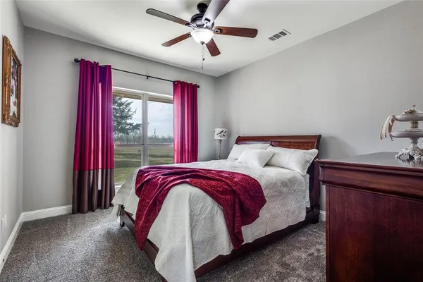 a bedroom with bed and a chandelier
