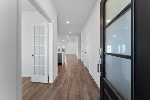 a view of a hallway with wooden floor