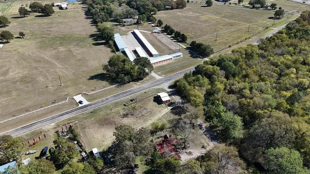 an aerial view of a house with a yard and lake view
