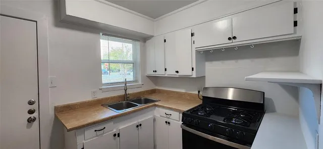 a kitchen that has a sink and a stove