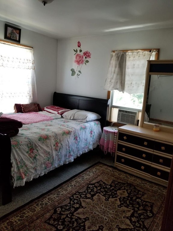 31 Russell Street West Springfield, MA 01089 - Photo 4 of 9 a bedroom with a bed and a flat screen tv