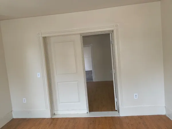 a view of room with wooden floor