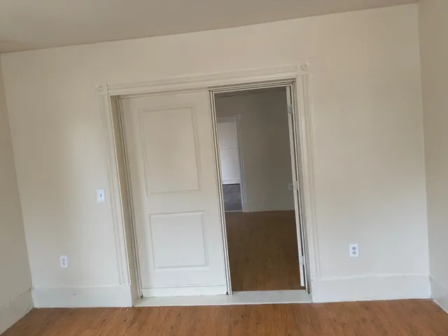 a view of room with wooden floor