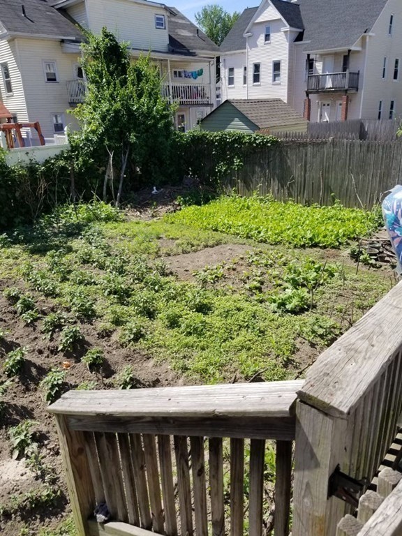 31 Russell Street West Springfield, MA 01089 - Photo 9 of 9 a backyard of a house with a yard and potted plants
