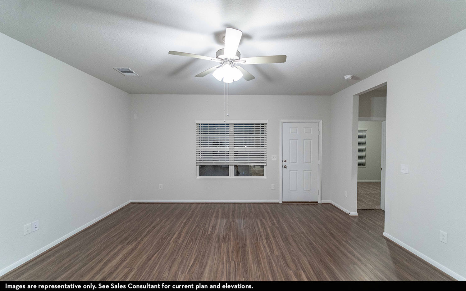 108 Zion Drive Kyle, TX 78640 - Photo 2 of 13 a view of an empty room with wooden floor and a window