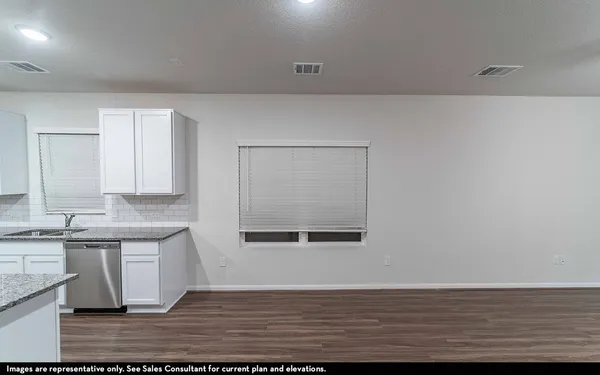 a view of a kitchen with wooden floor and a sink