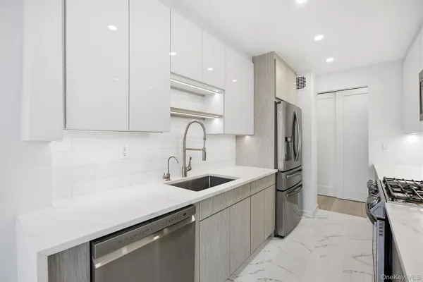 a kitchen with refrigerator and cabinets