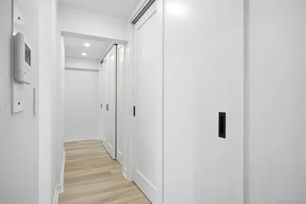 a view of a hallway with wooden floor and staircase