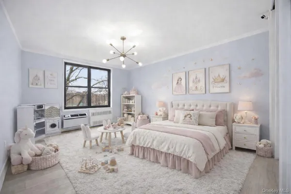 a spacious bedroom with a large bed and a chandelier