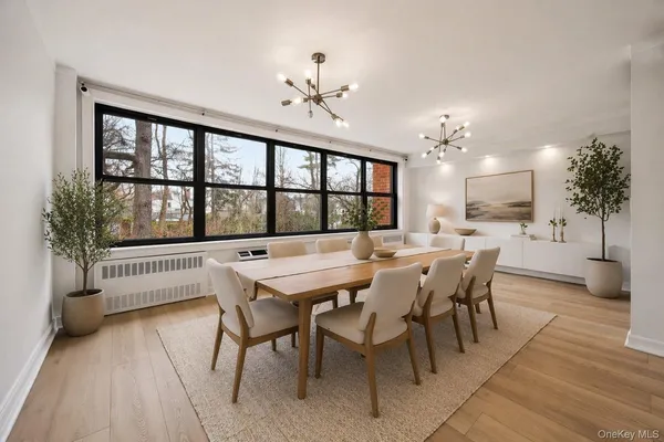 a view of a dining room with furniture window and wooden floor
