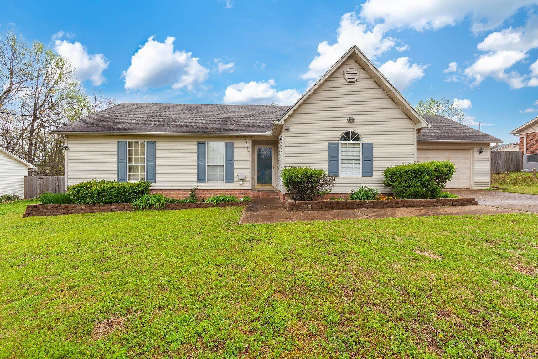 112 Penny Lane Jackson, TN 38301 - Photo 1 of 16 a front view of a house with garden