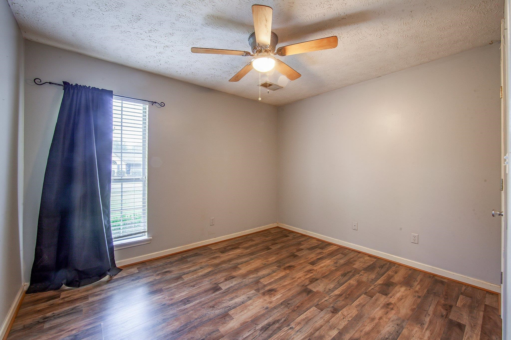 112 Penny Lane Jackson, TN 38301 - Photo 11 of 16 wooden floor in an empty room with a window