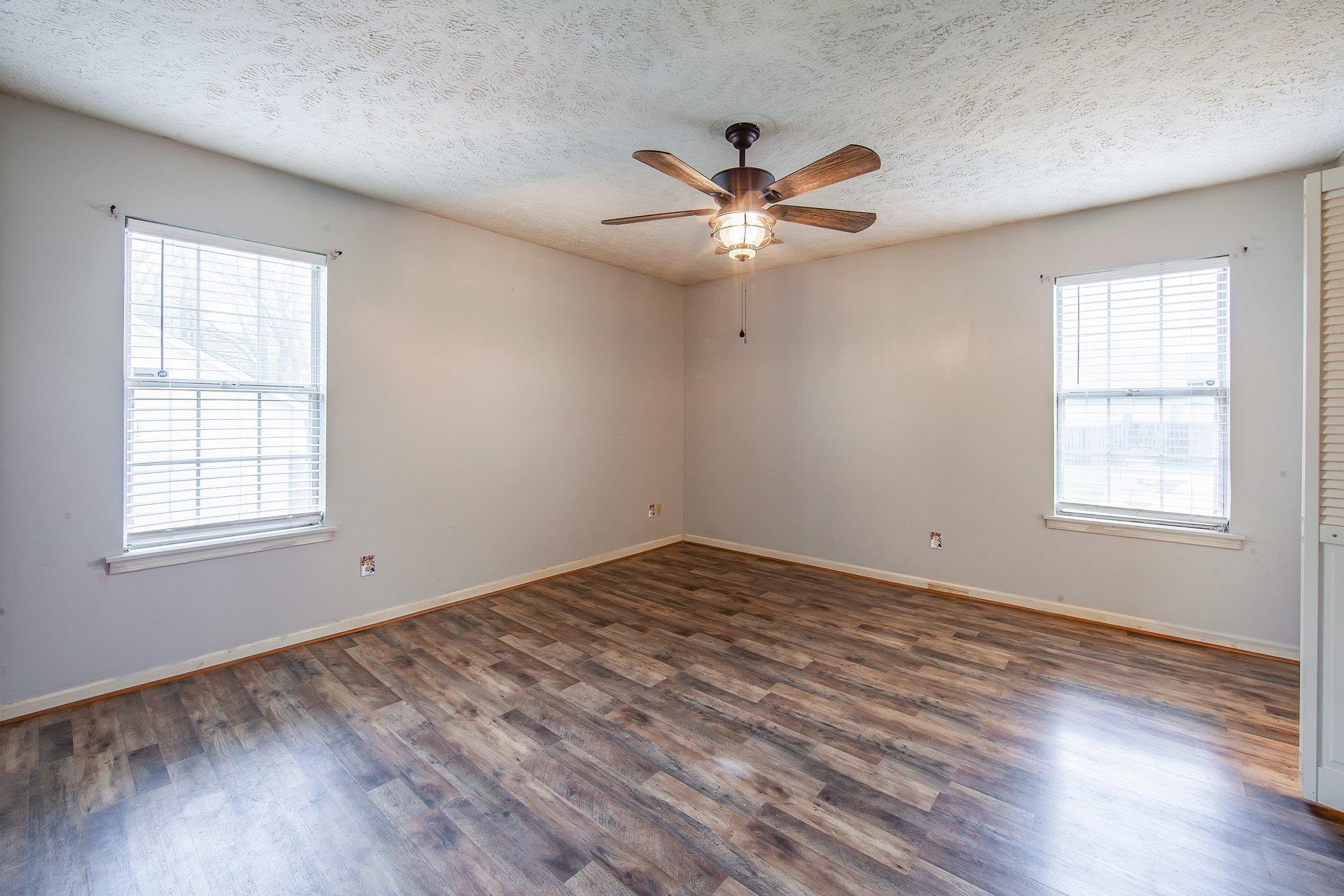 112 Penny Lane Jackson, TN 38301 - Photo 12 of 16 a view of empty room with wooden floor and fan