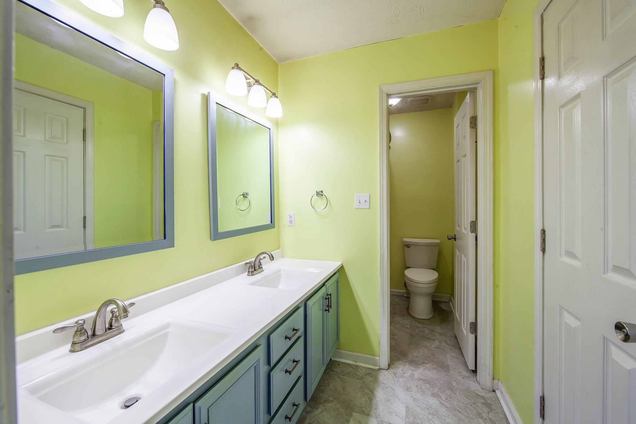 112 Penny Lane Jackson, TN 38301 - Photo 13 of 16 a bathroom with a double vanity sink mirror and toilet
