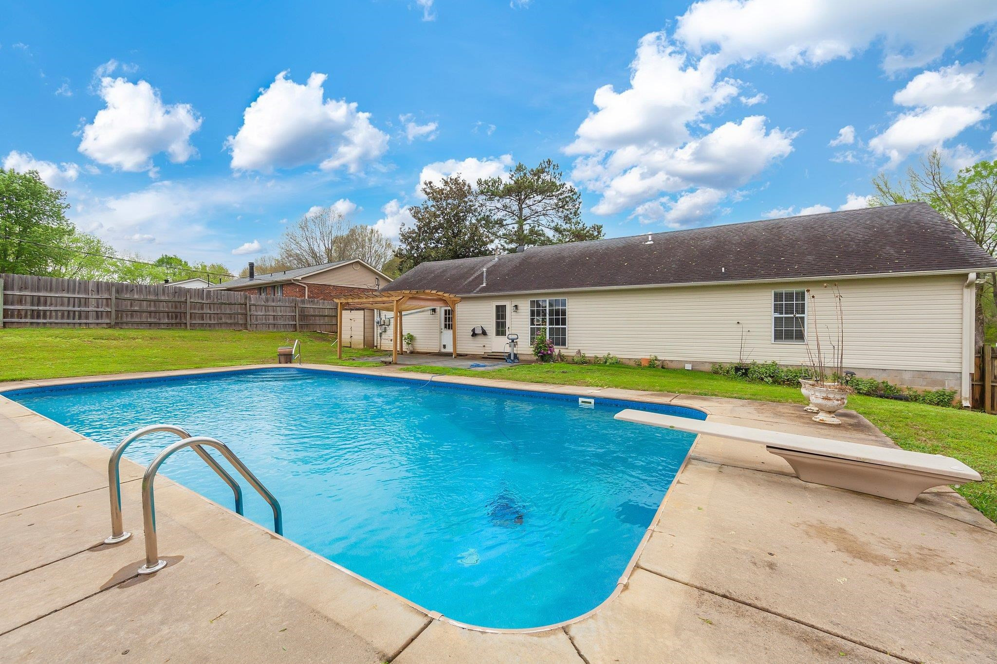 112 Penny Lane Jackson, TN 38301 - Photo 14 of 16 a view of a swimming pool with an outdoor seating and a yard