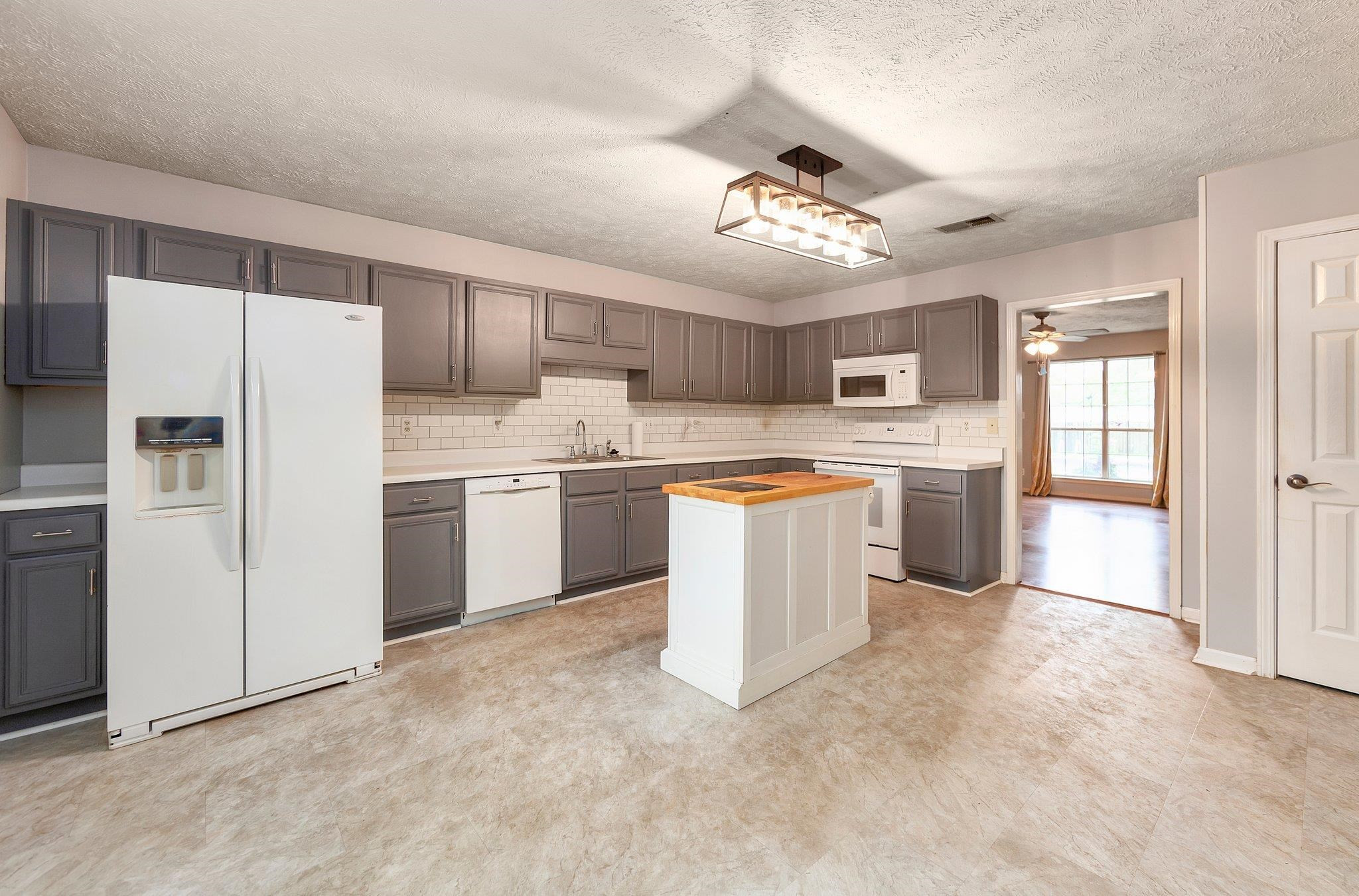 112 Penny Lane Jackson, TN 38301 - Photo 4 of 16 a kitchen with refrigerator cabinets and a sink