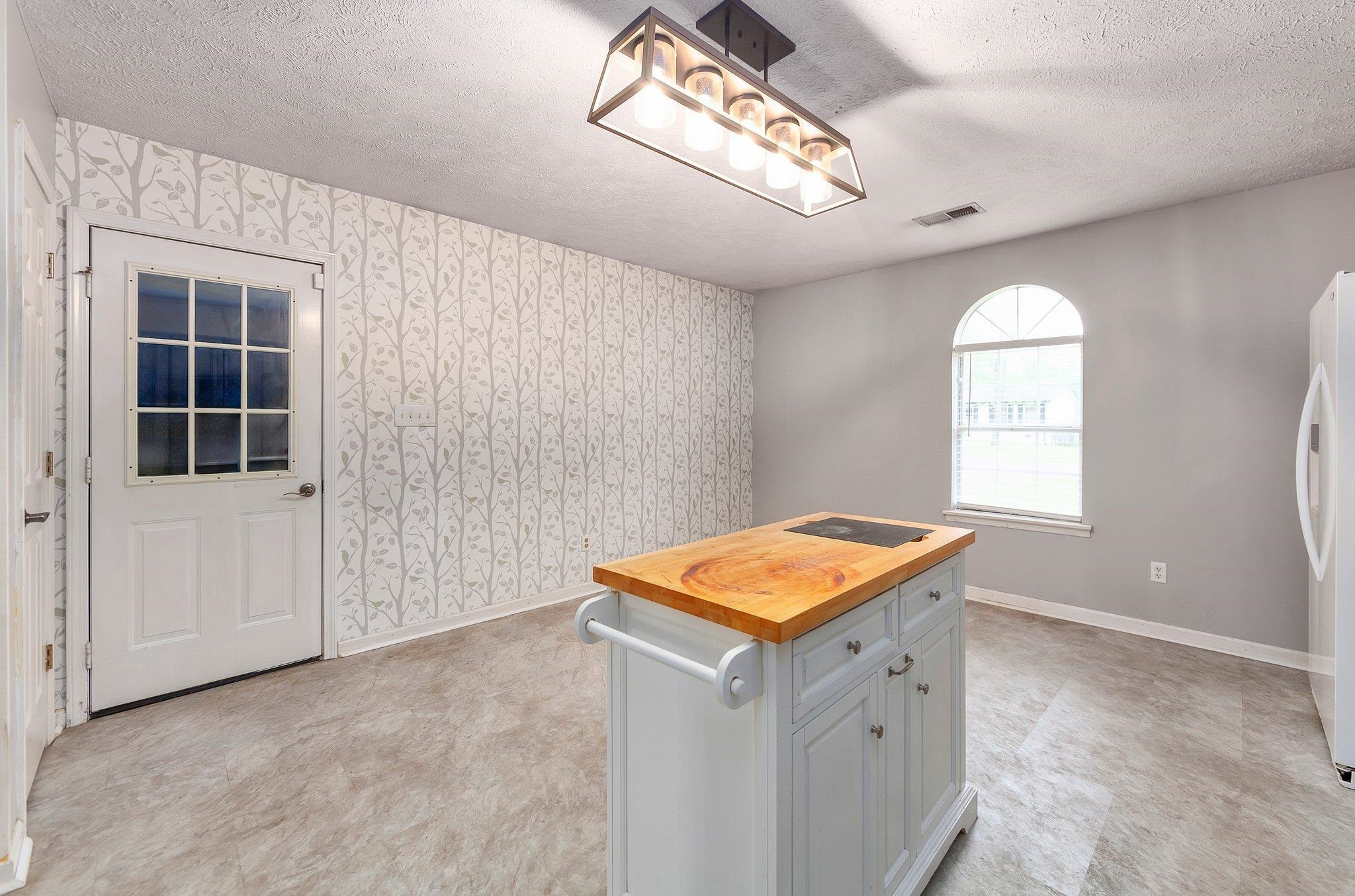 112 Penny Lane Jackson, TN 38301 - Photo 6 of 16 a room with window and chandelier
