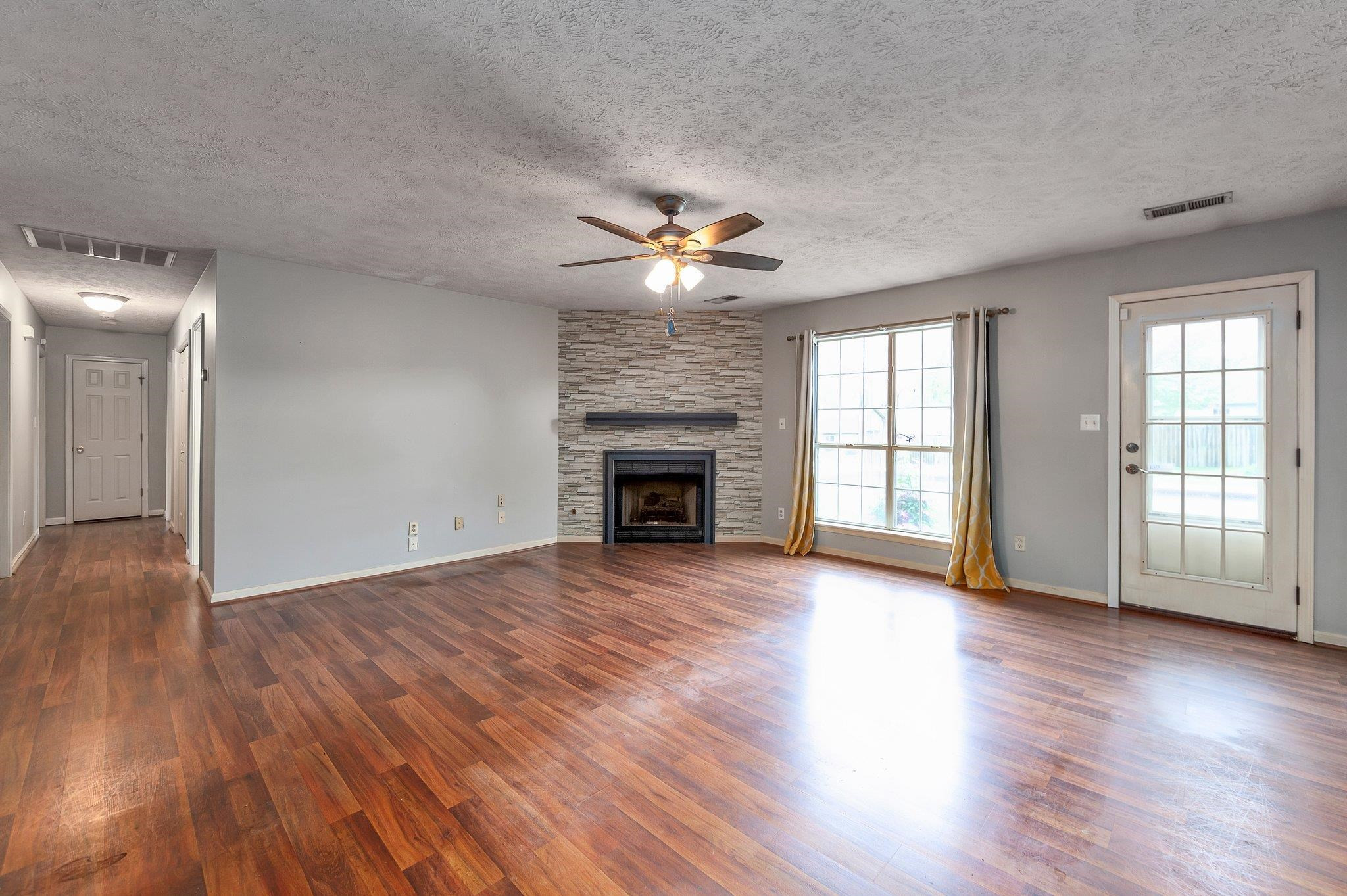 112 Penny Lane Jackson, TN 38301 - Photo 7 of 16 a view of an empty room with wooden floor and a window