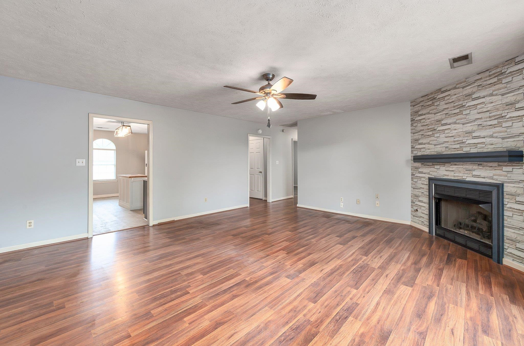 112 Penny Lane Jackson, TN 38301 - Photo 8 of 16 a view of an empty room with wooden floor and a fireplace
