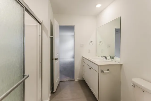 a bathroom with a sink toilet and shower