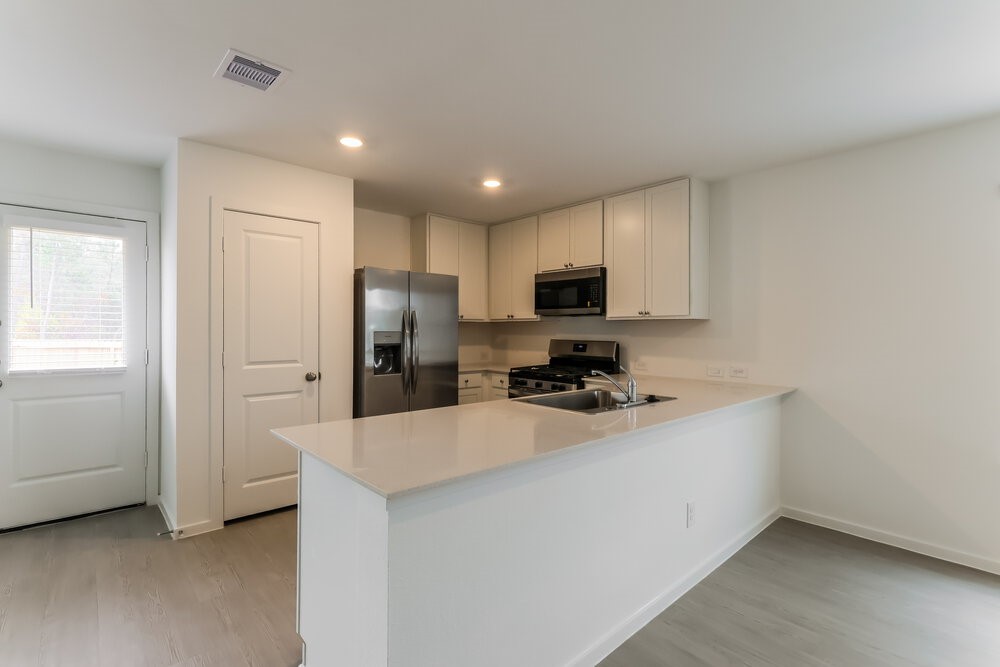 2084 Cedar Way Drive Conroe, TX 77301 - Photo 9 of 17 a kitchen with a refrigerator a sink and cabinets