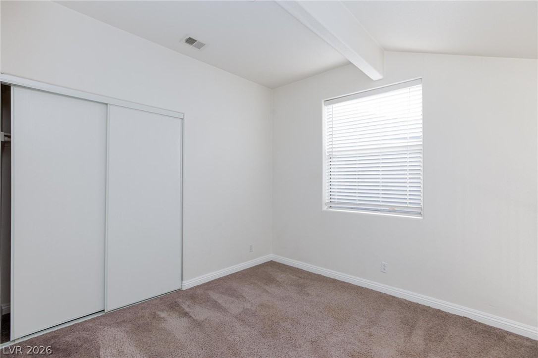 2246 Ramsgate Drive Henderson, NV 89074 - Photo 14 of 36 A well-lit bedroom features plush carpeting and convenient sliding closet doors.