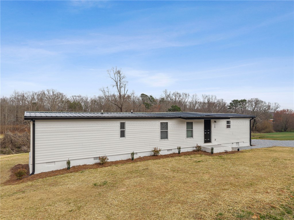 139 Davis Road Easley, SC 29640 - Photo 33 of 34 This newly constructed residence features a crisp white exterior and a durable metal roof.
