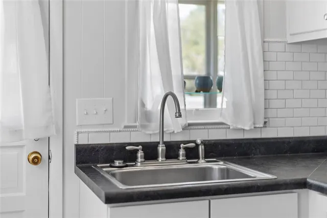 a kitchen with a sink and cabinets