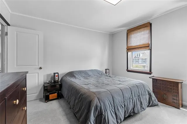 a bed sitting in a bedroom next to a window